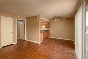 Port Arthur apartment for rent - A room with wooden floors and a ceiling fan.