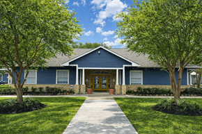 Beaumont apartment for rent - A blue house with a yellow door and a concrete walkway leading to it.