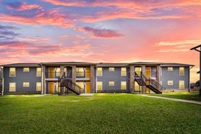 Beaumont apartment for rent - a row of condominiums at sunset with a pink sky
