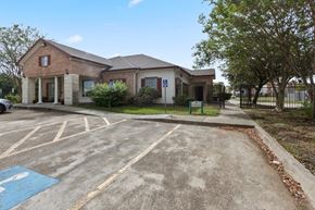 Houston apartment for rent - A parking lot with a handicap sign painted on the pavement.