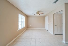 Port Arthur apartment for rent - an empty dining room with a ceiling fan