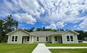 Lumberton apartment for rent - A house with a red door and a car parked in front.