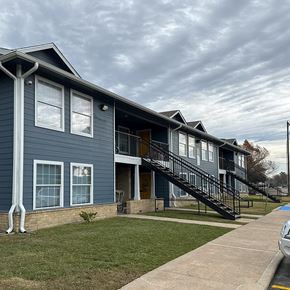 Beaumont apartment for rent - A blue building with a black staircase leading to the entrance.