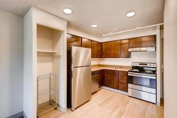 Denver apartment for rent - A kitchen with a refrigerator, oven, and stove.
