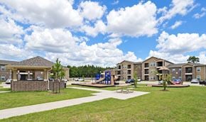Orange apartment for rent - A playground area in front of apartment buildings.