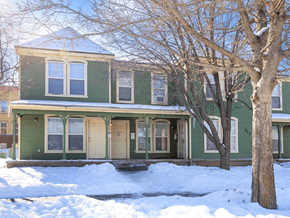 Greeley apartment for rent - A green house with a tree in front of it at Meeker Commons Apartments, Colorado