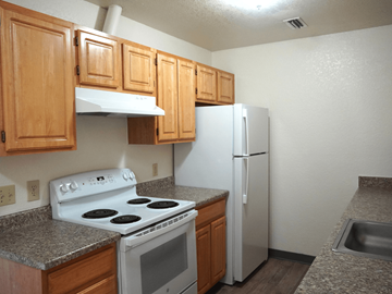 Grand Junction apartment for rent - A kitchen with a white stove and refrigerator.