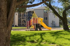 Fort Morgan apartment for rent - playground with yellow slide at Gateway Village Apartments in Fort Morgan, CO, 80701