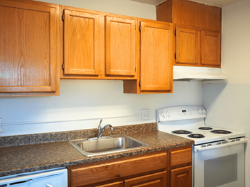 Denver apartment for rent - A kitchen with a stove, sink and cabinets.
