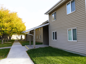 Grand Junction apartment for rent - A building with a brown siding and a white door at Grand Manor Apartments, Grand Junction, CO.