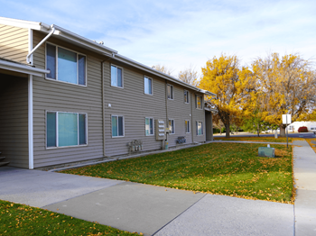 A building with a grey siding and a white roof.