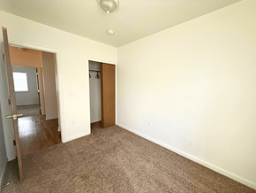 Lakewood townhouse for rent - A room with a carpeted floor and two doors.