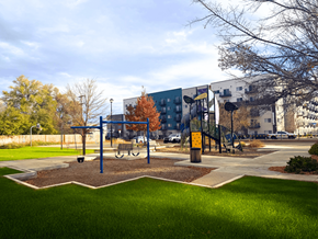Lakewood townhouse for rent - A park with a playground and a building in the background.