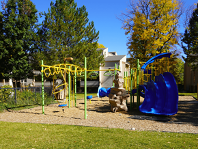 Denver apartment for rent - A playground with a blue slide and yellow equipment at Garden Court Apartments, Denver, Colorado