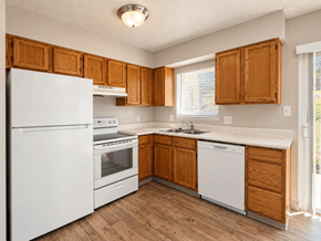 Westminster apartment for rent - A kitchen with white appliances and wooden cabinets.