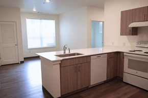 Fort Morgan apartment for rent - A kitchen with a white counter top and wooden cabinets.