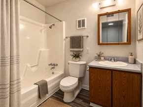 Arvada apartment for rent - A bathroom with a toilet, sink, and shower.