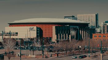 A large building with a red and white logo on the side of it.