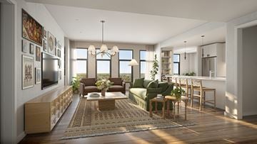 Bethesda apartment for rent - A modern living room with a green couch and a wooden floor.