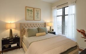 Rockville apartment for rent - A bedroom with a large bed and two lamps.