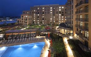 Rockville apartment for rent - A large building with a pool in front of it.
