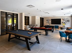 Norwalk apartment for rent - A pool table is in the middle of a room with a bar and a TV.