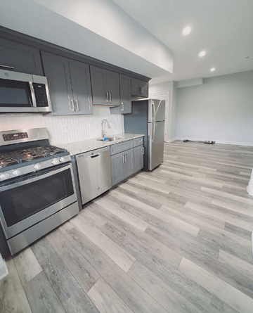 Stamford apartment for rent - A kitchen with a refrigerator, oven, and microwave.