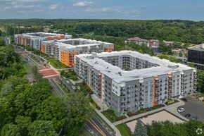 Norwalk apartment for rent - A large apartment complex with multiple buildings and a parking lot in front.