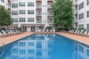Norwalk apartment for rent - A large swimming pool in front of a white apartment building.