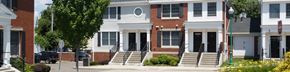 Stamford apartment for rent - A white house with a black door and windows.