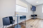 Pflugerville apartment for rent - A room with a table, chairs and a television.