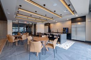 Austin apartment for rent - a dining room with tables and chairs and a kitchen