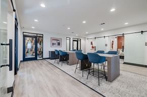 Del Valle apartment for rent - A conference room with blue chairs and a white table.