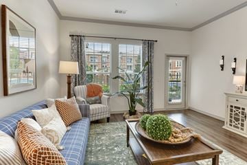 Frisco apartment for rent - A living room with a blue couch and a wooden coffee table.
