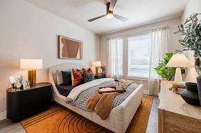 Austin apartment for rent - a bedroom with a bed and a ceiling fan