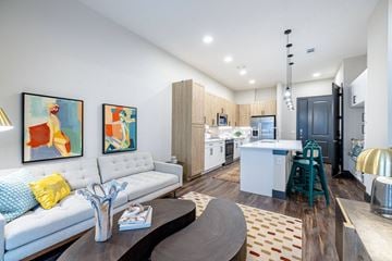 Austin apartment for rent - a living room and kitchen with a couch and a table