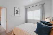 Pflugerville apartment for rent - A bedroom with a bed, pillows, and a picture on the wall.