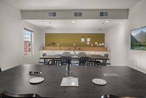 Frisco apartment for rent - A modern dining room with a long table and chairs.