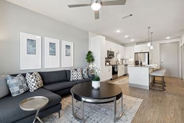 North Richland Hills apartment for rent - A living room with a grey couch and a coffee table.