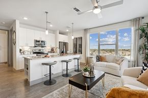 North Richland Hills apartment for rent - A modern kitchen with white cabinets and a bar area.