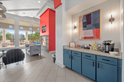 Austin apartment for rent - A kitchen area with blue cabinets and a red accent wall.