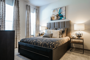 Manor apartment for rent - A bedroom with a large bed and a painting on the wall.