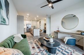 Austin apartment for rent - A living room with a green couch and a black coffee table.