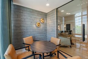 Farmers Branch apartment for rent - A modern dining room with a round wooden table and chairs.