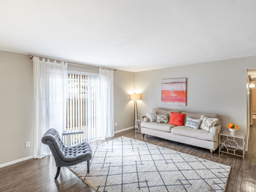 Dallas apartment for rent - A living room with a grey chair and a white sofa.