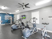 Dallas apartment for rent - A spacious gym with a variety of exercise equipment including treadmills, stationary bikes, and weight machines.