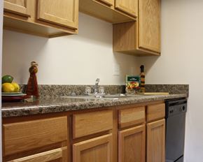 Blue Ash apartment for rent - a kitchen with wooden cabinets and granite counter top and a sink  at Hunter's Creek Apartments, Cincinnati, 45242