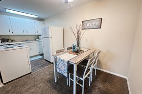 Southgate apartment for rent - A kitchen with a table and chairs in the middle of the room.
