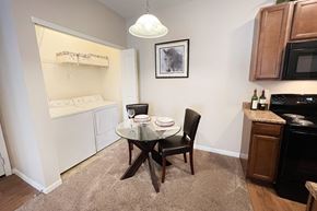Columbus apartment for rent - a kitchen and dining room with a small table and chairs at The Residences at Liberty Crossing, Columbus, 43235