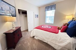 Columbus apartment for rent - a bedroom with a bed and a teddy bear in it at The Residences at Liberty Crossing, Columbus, OH, 43235